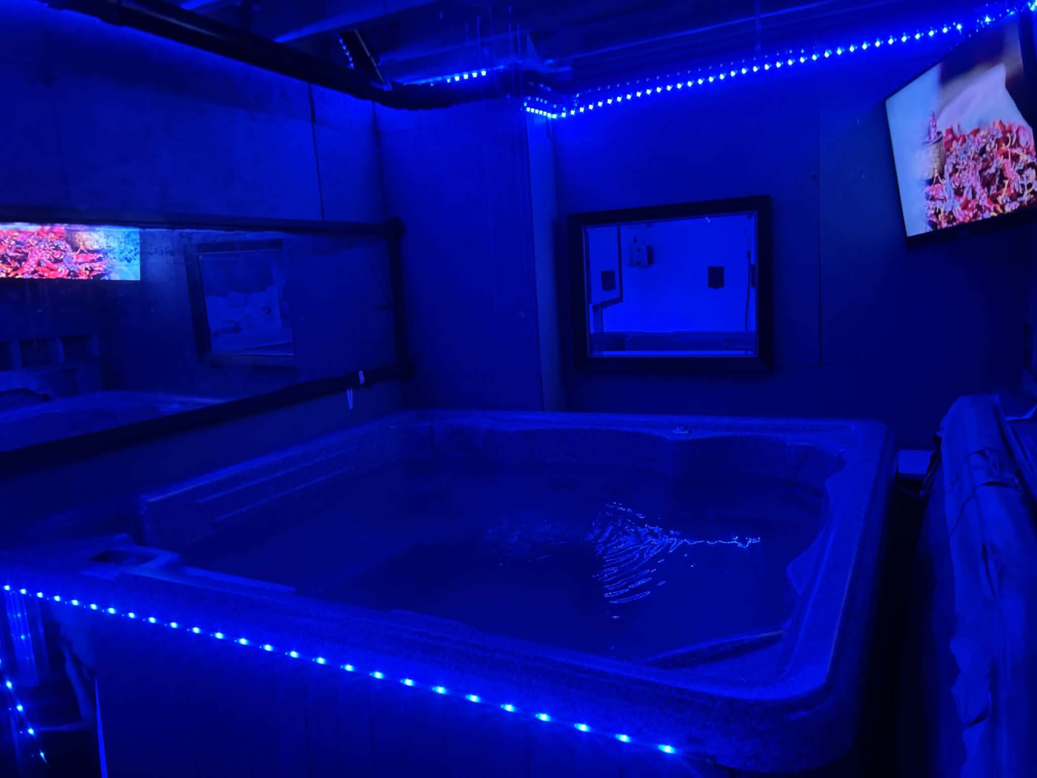 The blue-lit hot tub room